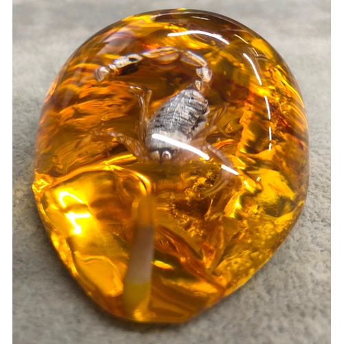 3340 - An amber resin nugget with a scorpion inside, 6cm long.