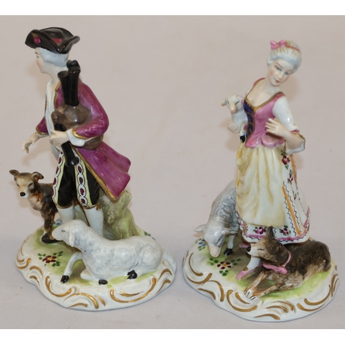 19 - A pair of Continental figures of a lady and gentleman with dog and sheep at their feet, 16.5cm high