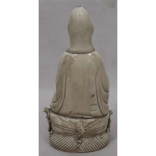 47 - An Oriental Blanc-de-Chine figure of seated Goddess holding a lotus leaf, 26.5cm high