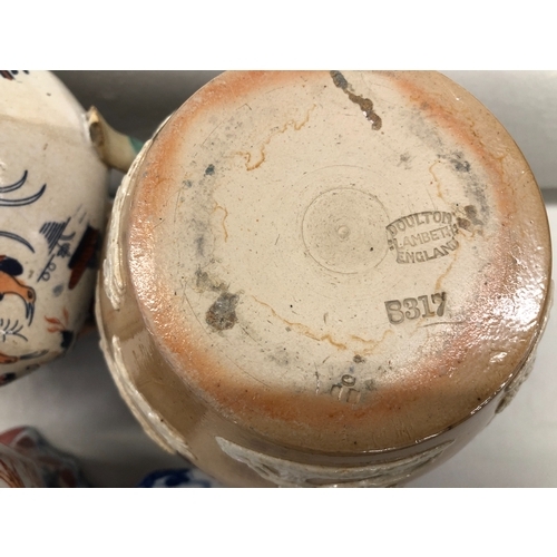 6022 - A Doulton Lambeth jug with silver rim, No. 8317, 17cm high, a small Mason's jug, 9.5cm high and 2 ot... 