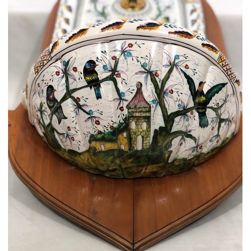 6047 - A wall mounted Portuguese hand painted ornate tap and sink on wood back, 83.5cm long. 41cm wide.
