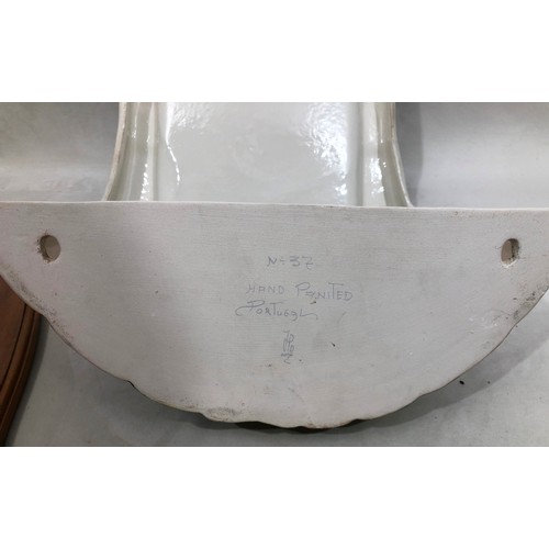 6047 - A wall mounted Portuguese hand painted ornate tap and sink on wood back, 83.5cm long. 41cm wide.