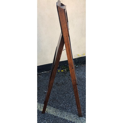 6051 - A child's easel 117cm high, 58cm wide. 48cm deep overall, with chalkboard, interior storage section ... 