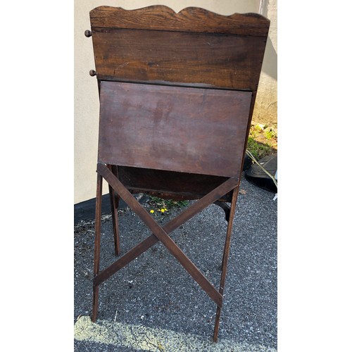 6051 - A child's easel 117cm high, 58cm wide. 48cm deep overall, with chalkboard, interior storage section ... 