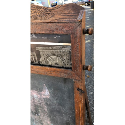 6051 - A child's easel 117cm high, 58cm wide. 48cm deep overall, with chalkboard, interior storage section ... 