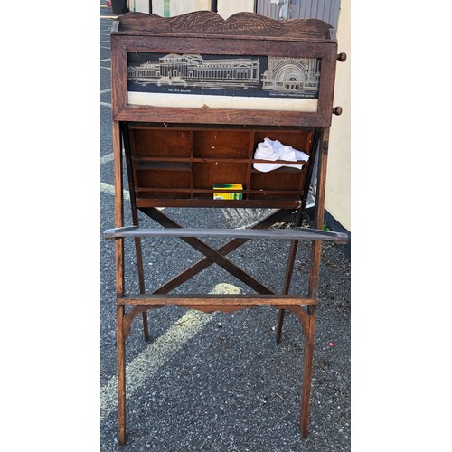 6051 - A child's easel 117cm high, 58cm wide. 48cm deep overall, with chalkboard, interior storage section ... 