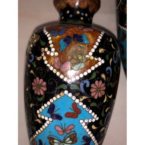 6055 - A Cloisonne vase, 26cm high and a pair of Cloisonne vases, 16cm high (both dented and damaged).