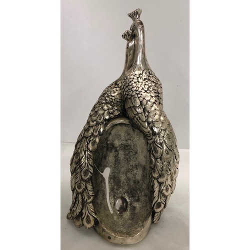 6056 - A heavy silver-coloured ornate clock in the form of 2 peacocks with central Quartz battery operated ... 