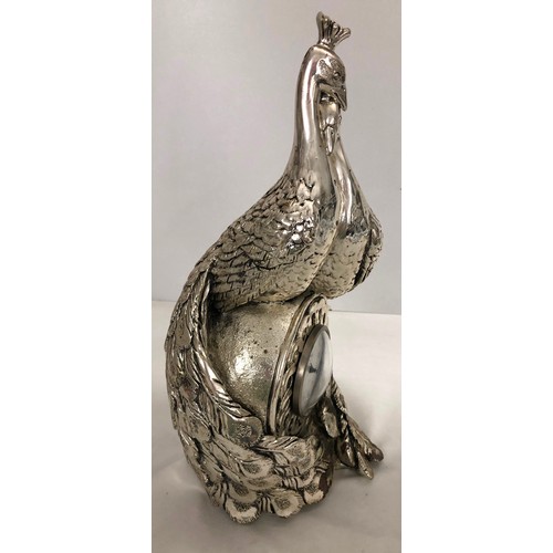 6056 - A heavy silver-coloured ornate clock in the form of 2 peacocks with central Quartz battery operated ... 