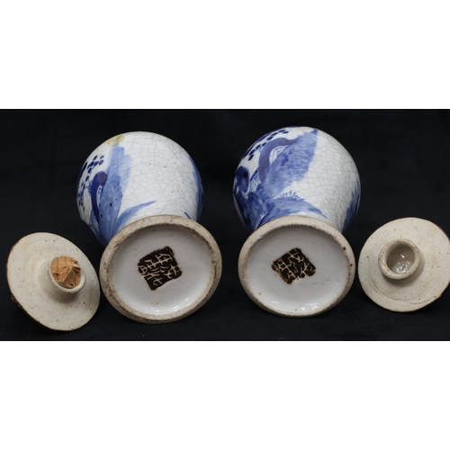 77 - A pair of Oriental blue and white round bulbous thin necked lidded vases with figure and landscape d... 