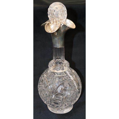 215 - A cut glass round bulbous thin necked decanter with stopper and Birmingham silver neck and scallop s... 