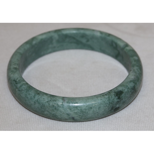 422 - A green hardstone bangle, inner measurement 6cm diameter