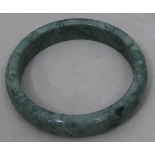 422 - A green hardstone bangle, inner measurement 6cm diameter