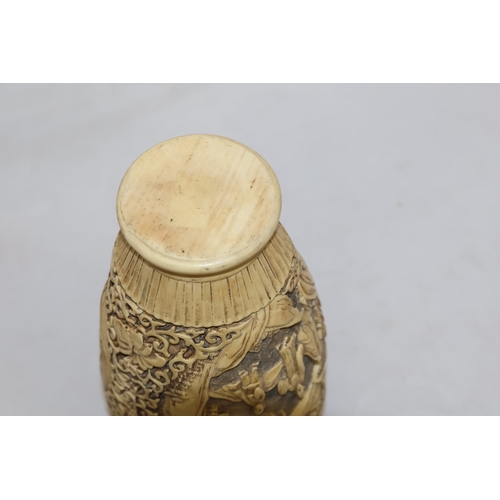 651 - A composition reproduction round bulbous thin necked vase with raised Oriental figure, floral and sc... 