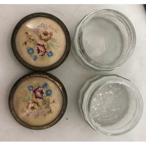 6042 - A part gilt metal dressing table set with embroidered detail, mirror, brush and 2 glass lidded pots ... 