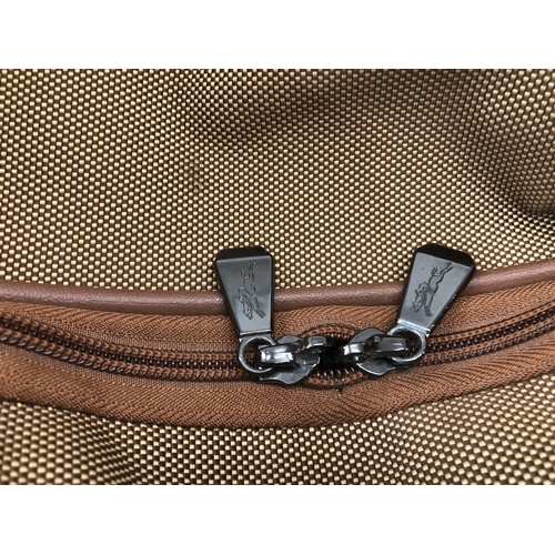 7012 - A Longchamp large wheeled travel bag, 71cm long, 33cm deep, 41cm high.