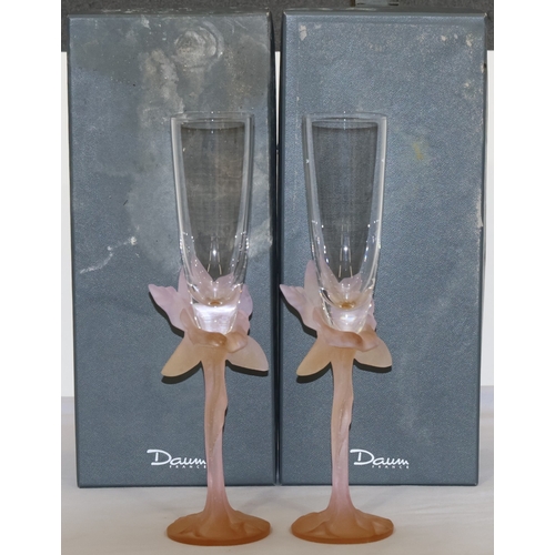 62 - A pair of Daum pink glass champagne flutes with raised floral motifs, 27.2cm high (original boxes ha... 
