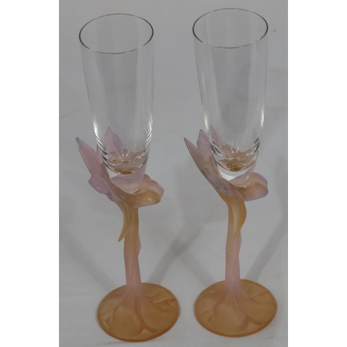 62 - A pair of Daum pink glass champagne flutes with raised floral motifs, 27.2cm high (original boxes ha... 