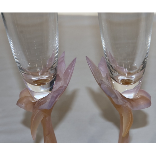 62 - A pair of Daum pink glass champagne flutes with raised floral motifs, 27.2cm high (original boxes ha... 