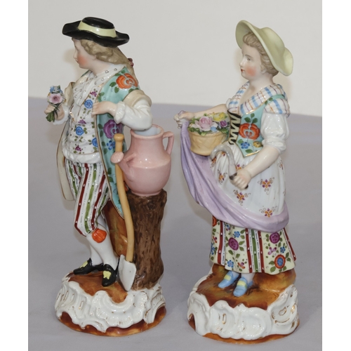 72 - A pair of Continental china figures of farming gentleman and wife holding implements and encrusted f... 