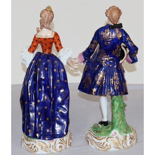 73 - A pair of large Derby style 19th Century porcelain figure of standing gentleman and lady with allove... 