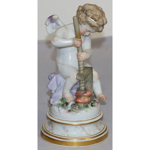 74 - A Meissen porcelain figure of a seated winged cupid pressing 2 hearts together, on round sweeping ba... 