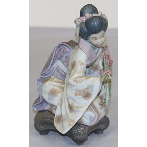 78 - A Lladro figure of a kneeling Oriental lady with encrusted floral decoration, 17.5cm high