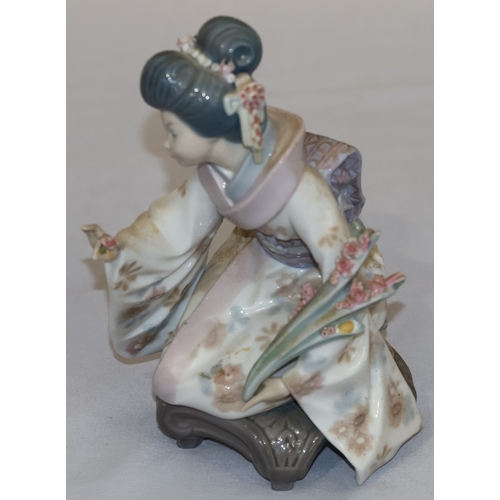 78 - A Lladro figure of a kneeling Oriental lady with encrusted floral decoration, 17.5cm high