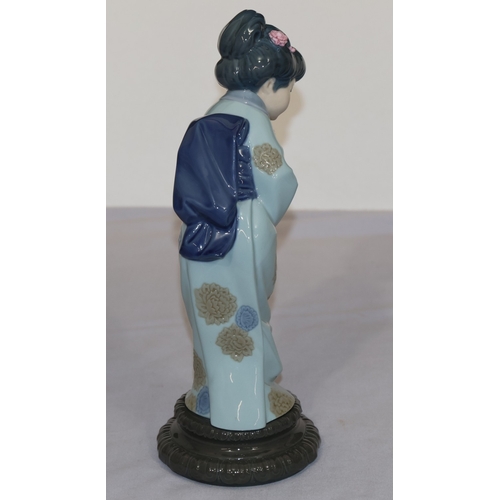 79 - A Lladro figure of a standing Oriental lady with encrusted flowers in her hair, 26cm high