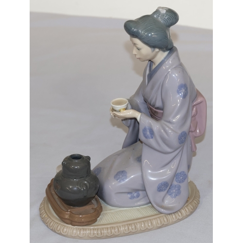 80 - A Lladro figure of a kneeling lady holding a cup, 22cm high