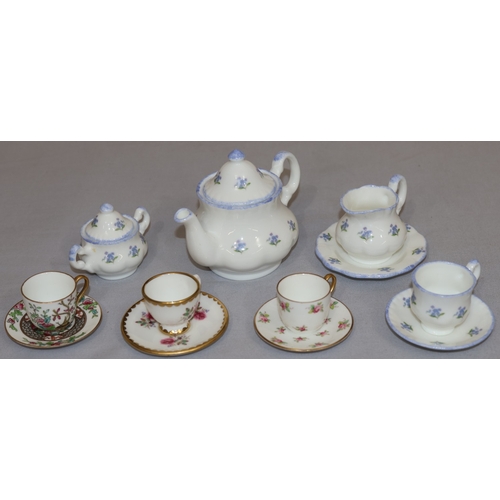 85 - 3 Coalport miniature cups and saucers with floral decoration and a Harrods miniature tea service on ... 