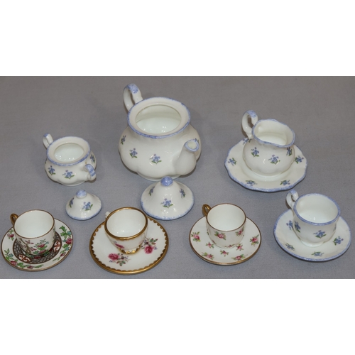 85 - 3 Coalport miniature cups and saucers with floral decoration and a Harrods miniature tea service on ... 