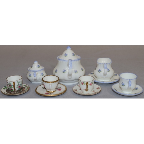 85 - 3 Coalport miniature cups and saucers with floral decoration and a Harrods miniature tea service on ... 