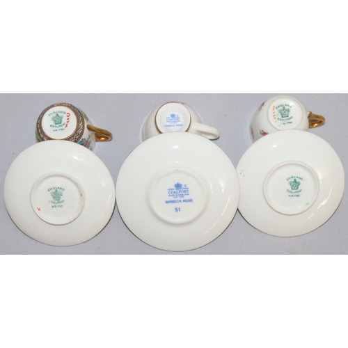 85 - 3 Coalport miniature cups and saucers with floral decoration and a Harrods miniature tea service on ... 