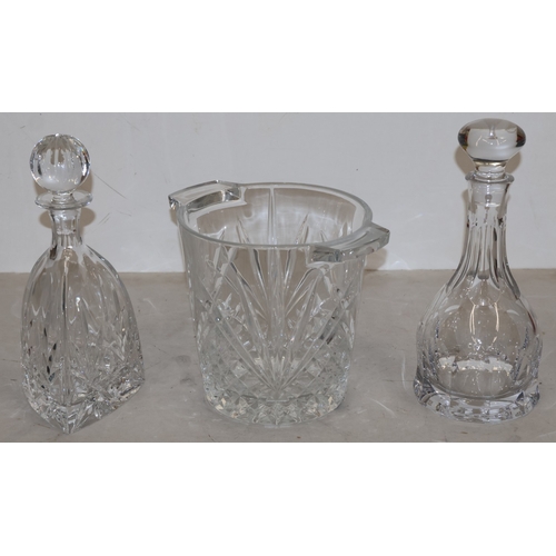 91 - A heavy cut glass round 2-handled ice bucket, 20cm high (slight chip to base) and 2 cut glass decant... 