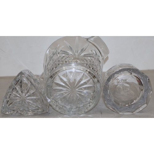 91 - A heavy cut glass round 2-handled ice bucket, 20cm high (slight chip to base) and 2 cut glass decant... 