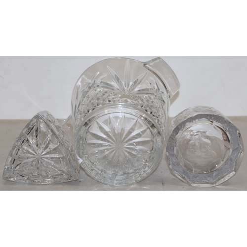 91 - A heavy cut glass round 2-handled ice bucket, 20cm high (slight chip to base) and 2 cut glass decant... 