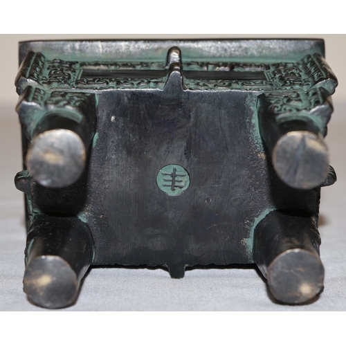 An Oriental bronze rectangular shaped 2-handled censer with allover ...