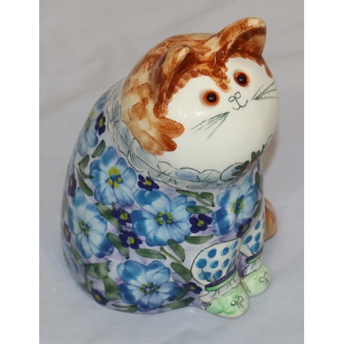17 - Joan De Bethel, Cinque Ports Pottery seated cat figure wearing blue floral jacket, 12.5cm high