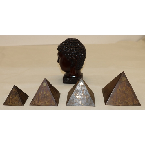 3006 - A composition Buddha head, 15.56cm high and 4 graduated composition pyramids, tallest 9cm high. (5)