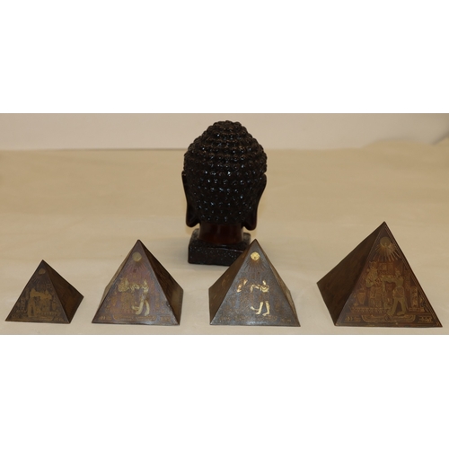3006 - A composition Buddha head, 15.56cm high and 4 graduated composition pyramids, tallest 9cm high. (5)
