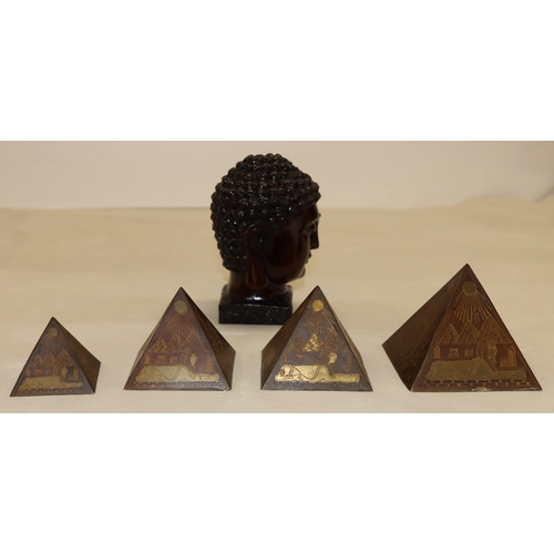 3006 - A composition Buddha head, 15.56cm high and 4 graduated composition pyramids, tallest 9cm high. (5)