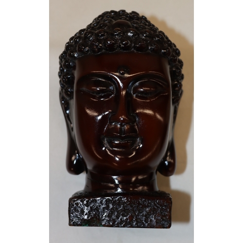 3006 - A composition Buddha head, 15.56cm high and 4 graduated composition pyramids, tallest 9cm high. (5)