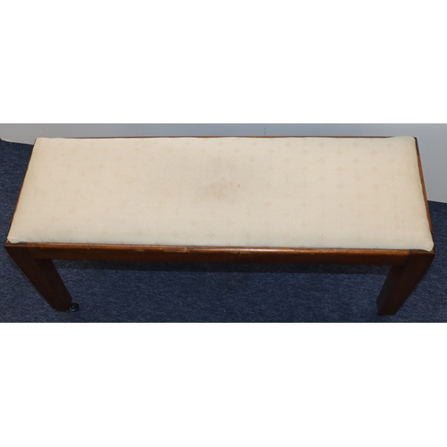 3008 - A rectangular footstool with cream fabric upholstered seat on castors, 86cm wide, 29cm deep, 41.5cm ... 