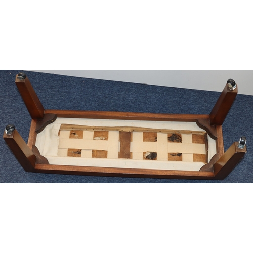 3008 - A rectangular footstool with cream fabric upholstered seat on castors, 86cm wide, 29cm deep, 41.5cm ... 