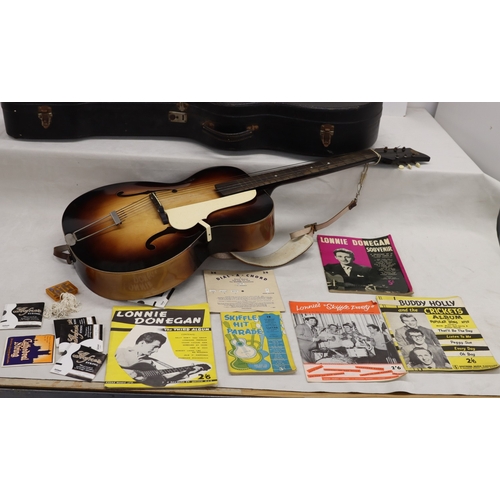 3023 - An acoustic Voss guitar with leather strap, various music books, spare strings and hard case (wear t... 