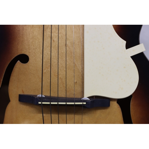 3023 - An acoustic Voss guitar with leather strap, various music books, spare strings and hard case (wear t... 