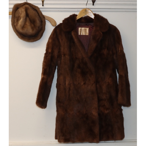3029 - A mid length fur coat with belt, Brahams Furriers label, 88cm long, shoulder to cuff length 60cm lon... 