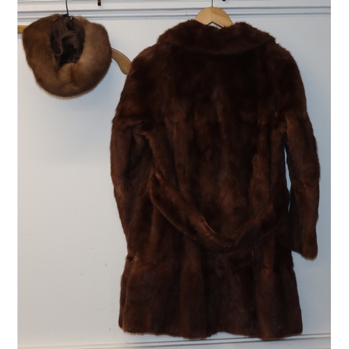 3029 - A mid length fur coat with belt, Brahams Furriers label, 88cm long, shoulder to cuff length 60cm lon... 