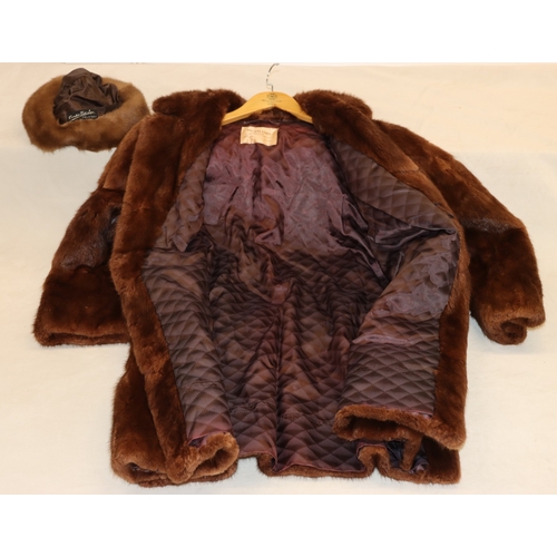 3029 - A mid length fur coat with belt, Brahams Furriers label, 88cm long, shoulder to cuff length 60cm lon... 